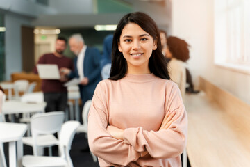 Portrait of smiling confident young Asian businesswoman, manager wearing casual clothes