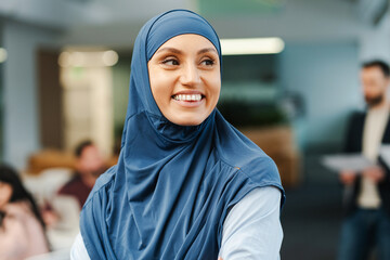 Portrait of cheerful smiling Muslim woman, businesswoman wearing hijab, looking away
