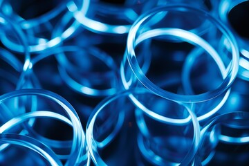 Neon blue geometric circles overlap and intersect, forming a visually striking composition in a closeup shot