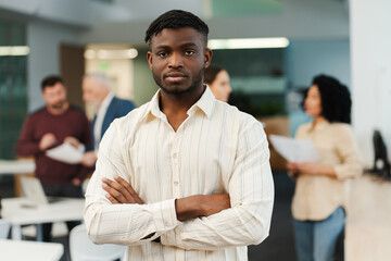 Serious, successful African American man, young businessman, ?eo with crossed arms looking at camera
