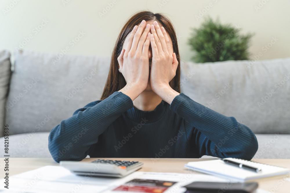 Wall mural young asian woman cover her face after stressed with monthly bill expenses and credit card debt.