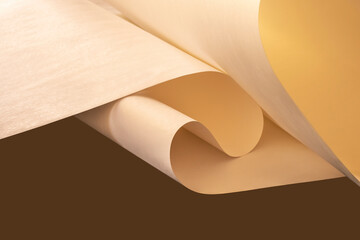 A large sheet of warm-colored paper on a brown background.
