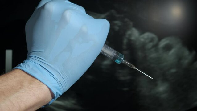 Kill baby in womb. A female hand stop the doctor arm with syringe. A concept of stop medical abortion and woman's health problems.