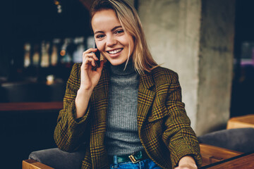 Half length portrait of successful young businesswoman dressed in stylish outfit smiling at camera...