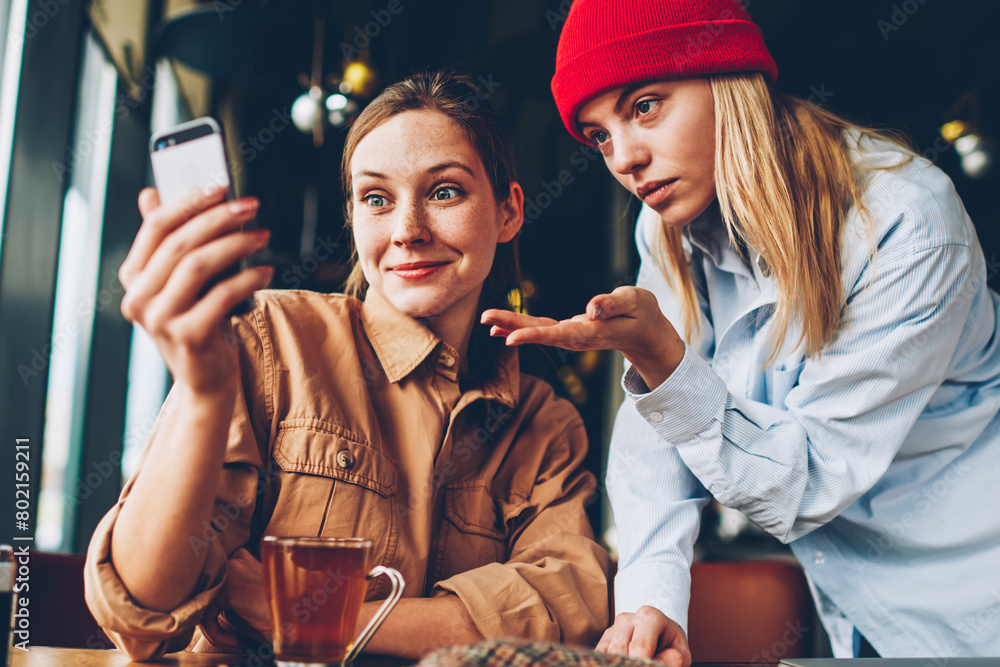 Poster wondered hipster bloggers discussing video on website wich watching online on smartphone device conn