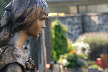 A statue of a woman with a flower in her hair