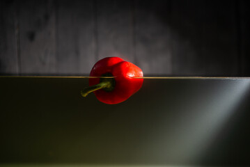 Red bell peppers float in the water