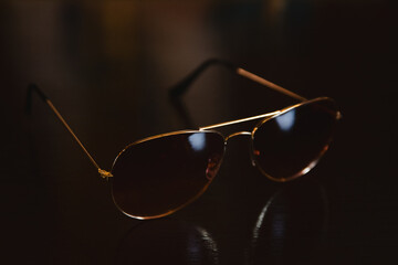 sunglasses on black background