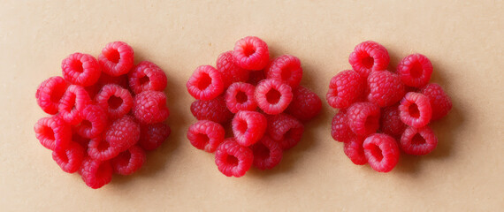 Sliced raspberries creatively placed on a beige background . AI generated.