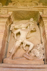 Carved figure of lord Vishnu, Varah Avatara  with his foot on the snake in the Durga temple, The Galaganatha Group of temples. Aihole, Bagalkot, Karnataka, India.
