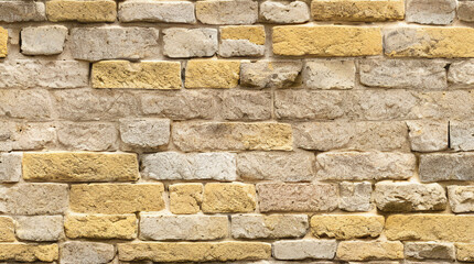 Fototapeta premium Stone Wall Texture. Brick Wall Background. Rough Stone Surface. Ancient Brickwork. Weathered Vintage Old Masonry Rustic Aged Architecture Pattern Urban Yellow