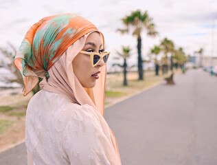 Fashion, sunglasses and Muslim woman in city with style, trendy clothes and casual outfit in Saudi Arabia. Religion, hijab and Islamic person with confidence, pride and cosmetics on summer weekend