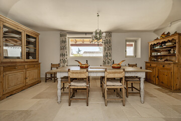A dining room in a country house with rustic-style wooden furniture