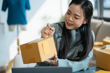 entrepreneur or freelance checking orders from customers, woman runs an e-commerce business on websites and social media.