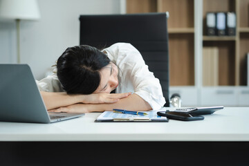 Asian businesswoman works at home until her body is tired, she is drowsy during the daytime. female wants to sleep during the day concept.