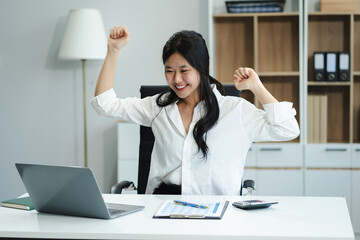 Excited woman work distant on computer talk on cellphone celebrate online win. Happy young female...
