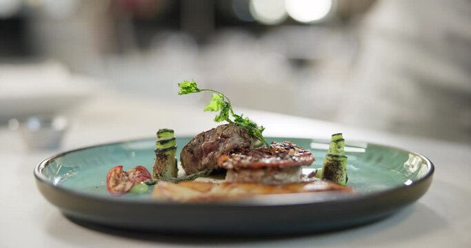 Restaurant, steak and plate with meat on luxury, gourmet or fine dining menu with spices and herbs. Grill, beef and catering dinner closeup with healthy protein, food or cooking in kitchen at hotel