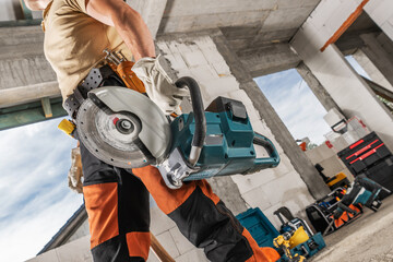 Construction Worker with a Professional Circular Saw in His Hand