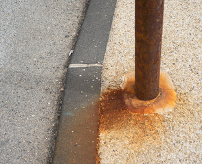 Rusty pole in a street 