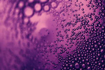 air bubbles in transparent liquid in colorful pink neon light