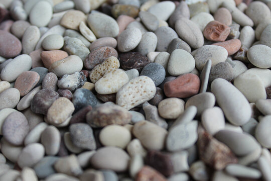 Background texture of pebbles or small river stone, flat lay or top view