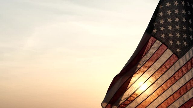 Concept of Memorial Day, Remember and Honor, 4th of July, Independence Day, Veteran Day, Holiday, Celebration. American USA flag waving in sunset outdoor background for honoring, mourning USA military