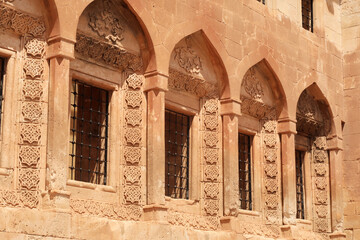 Row of barred windows in original ottoman architecture inside of the Ishak Pasha Palace, Sarayi, Dogubeyazit, Turkey - obrazy, fototapety, plakaty