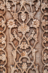 flower pattern Uzbek traditional ornament on wooden carved door in Tashkent in Uzbekistan close-up