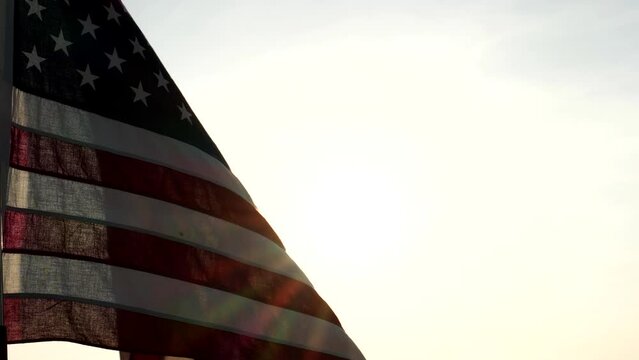 Concept of Memorial Day, Remember and Honor, 4th of July, Independence Day, Veteran Day, Holiday, Celebration. American USA flag waving in sunset outdoor background for honoring, mourning USA military