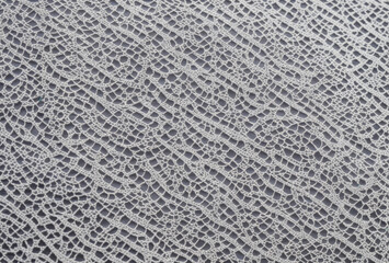 High-resolution showcase of retro lace fabric in monochrome, focusing on detailed decorative elements. AI generated.