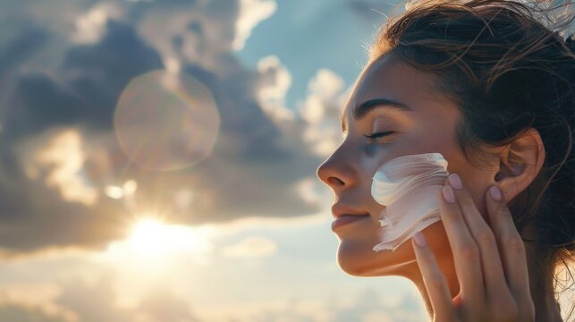 a woman outdoors applying sunscreen