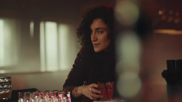 Man approaching woman at the bar