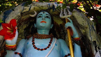 a sculpture of god shiva holding trident