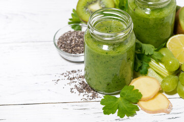 green fruit and vegetable smoothies in jars, top view