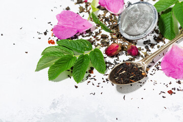ingredients for making tea with wild rose on a white background