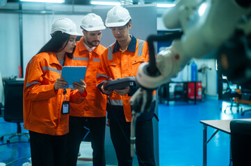 A group of Robotics engineers working with Programming and Manipulating Robot Hand, Industrial...