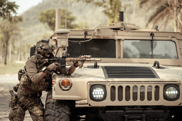 United States Army in camouflage uniforms operation in the forest.with armored vehicle, soldiers...
