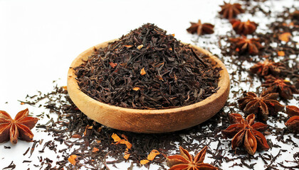 Black tea in wooden plate. Ceylon tea Orange Pekoe in small wood bowl close up.