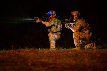Naklejka premium Soldiers ready to fire during Military Operation at night