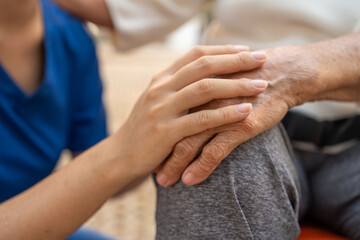 Close up of the hand of a nurse and an elderly woman. Caregiver and patient, Consolation, encouragement, concern, take care, careful. Health insurance.