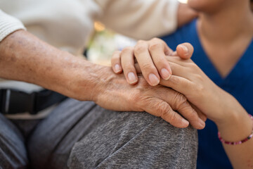 Close up of the hand of a nurse and an elderly woman. Caregiver and patient, Consolation, encouragement, concern, take care, careful. Health insurance.