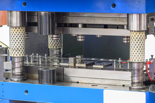 The metalworking process by progressive die in the light blue scene.