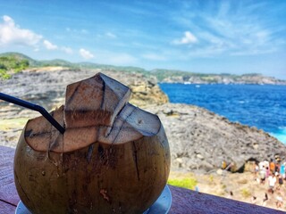 enjoy a young coconut with a view of the beach