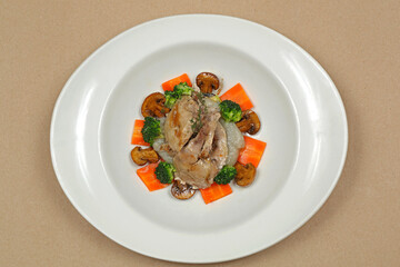 Grilled Quail Game Bird With Mushrooms and Vegetables Dinner Served in Oval Plate