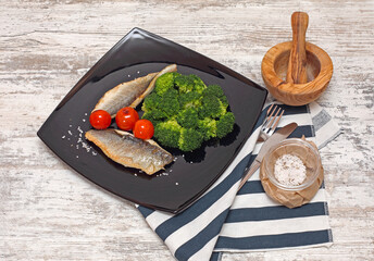 Grilled Fish Fillets and Cherry Tomatoes Broccoli Served at Black Plate