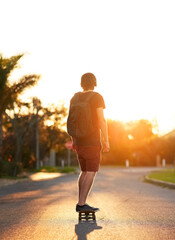 Young man, back and sports with skateboarding on urban street for travel, exercise and hobby. Male...