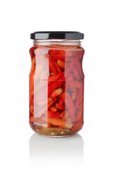 Red peppers in a glass jar isolated on white.