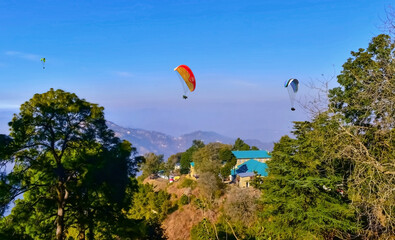 Beautiful landscape view with Paragliders in the sky at Bir Billing Himachal Pradesh.