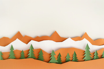 Minimalist paper cutout of mountain range with trees