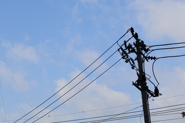 The sky overlooking the electric poles